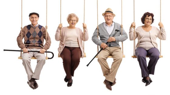 Seniors smiling on a swing