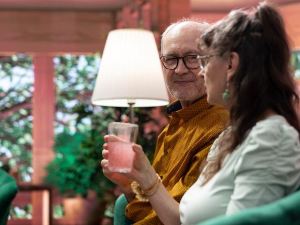 Older couple enjoying a conversation in a comfortable home setting while planning for a new chapter in life.