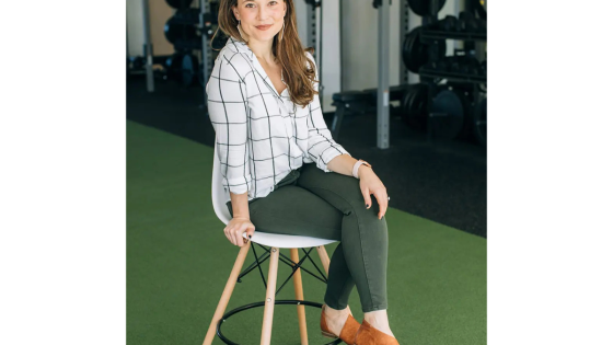 Kristin Oja, DNP, functional medicine practitioner and founder of STAT Wellness, seated in a wellness clinic before appearing on the Living to 100 Club podcast.